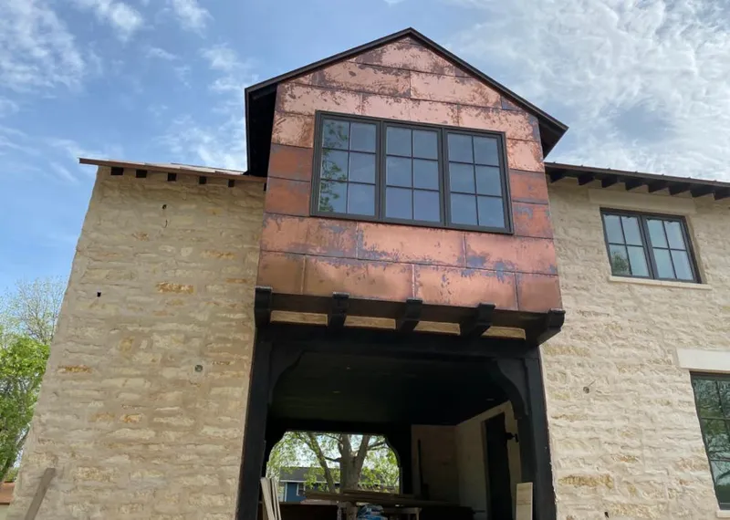 Copper metal panel facade on a stone building for Skylight Installation in Morris